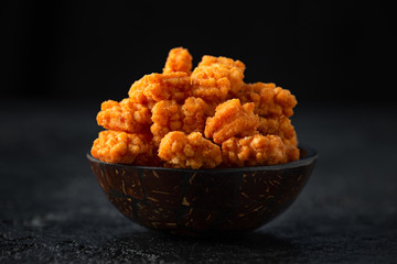 Vegetarian Beer snack chilli rice crackers on dark background