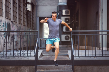 Young man jogging through an urban area of the city
