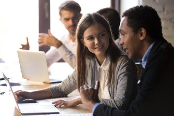 African American businessman mentor helping new female employee intern