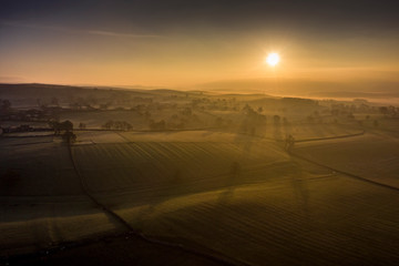 Fototapeta na wymiar Sunrise over a tree in the Yorkshire Dales