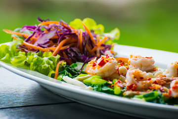 spicy shrimp salad with kale on dish.Thai food.
