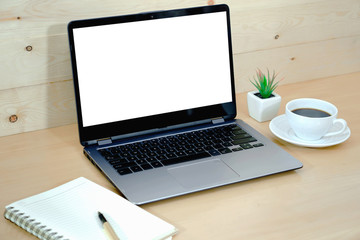 Coffee cup and laptop in office table