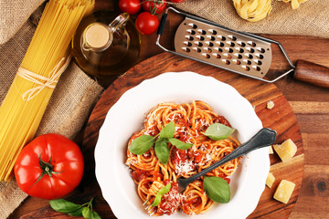 Plate of delicious spaghetti Bolognaise or Bolognese with savory minced beef and tomato sauce garnished with parmesan