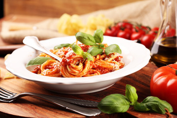 Plate of delicious spaghetti Bolognaise or Bolognese with savory minced beef and tomato sauce garnished with parmesan