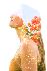 Double exposure profile of a natural beauty with lush orange flowers which seemingly grow from her...