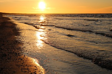 Bright orange sunset on the coast of the Gulf of Riga at the end of summer