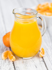 Homemade Tangerine Juice on a wooden table (selective focus)