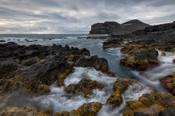 Obraz premium tide landscape at Poto do Comprido with a view on the new land of Capelinhos after the volcanic eruptions of 1957-1958