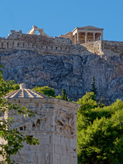 Athens Greece, ancient temple on acropilis hill over roman winds tower, street view