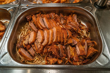 Asian fast food style, fried duck with Chinese noodles at big metal tray