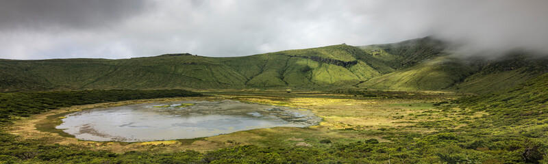 Fototapeta na wymiar Landscape panorama at Lagoa Branca caldera crater lake on the Azores island of Ilha das Flores
