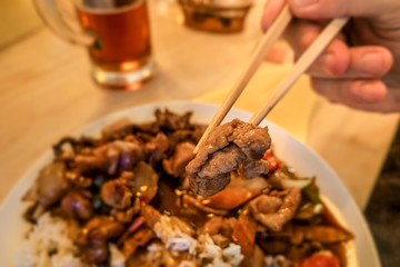 Asian fast food style, fried chicken with vegetables, rice and wooden chopsticks