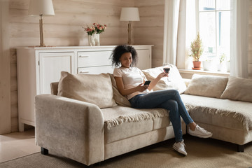 African American woman relax on couch enjoying weekend