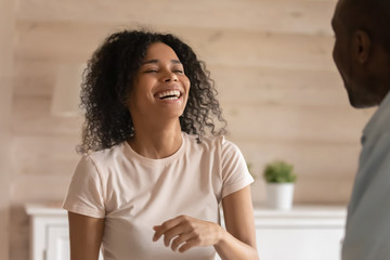 Fototapeta premium Happy african American woman laugh talking with husband