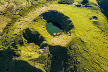 Aerial image of typical green volcanic caldera crater landscape with volcano cones of Planalto da...