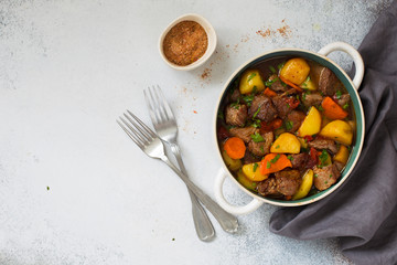 Beef stewed with vegetables on a stone  background