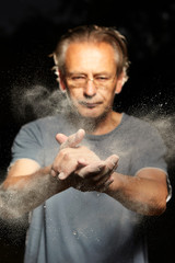 Man clapping hands to remove dust and dirt from skin