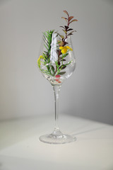 vintage composition, glass with different flowers and shadows on a white background