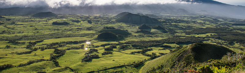 aerial like landscape from Pico da Urze overlooking the typical gree countryside of Planalto da Achada plains of Ilha do Pico island with several old volcano craters, calderas and cones, Azores