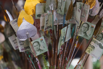 Cash bills on sticks in a temple