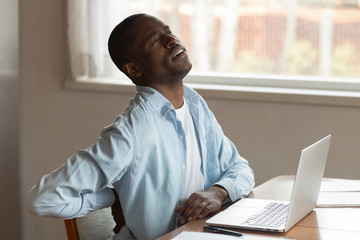 Hurt biracial man suffer from lower back pain