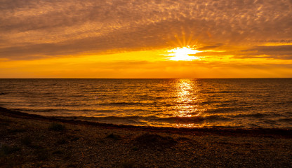 Sunset on the island Öland with the swedish mainland on the horizon