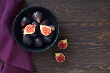 Ripe figs on a dark wooden table