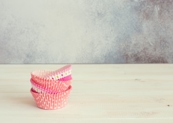 Vintage empty muffin paper tins close up. Selective focus