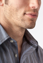 Close-up of man's chin and jawline with facial hair beard stubble five o'clock shadow. Men's...