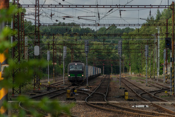 Fototapeta na wymiar Electric railway track in Dasnice station in west Bohemia in summer afternoon