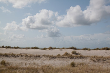 fluffy clouds beach dunes sand wind sylt