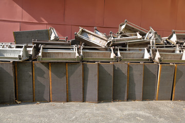 Broken old steps of the metro escalator are thrown out in the production yard