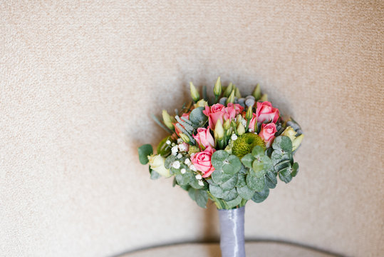 Wedding bouquet of roses, eustom and eucalyptus on beige . Copy space