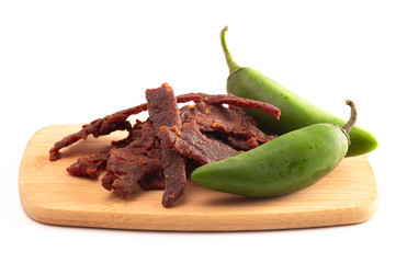Jalapeno Flavored Gourmet Beef Jerky on a Wooden Cutting Board