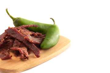 Jalapeno Flavored Gourmet Beef Jerky on a Wooden Cutting Board