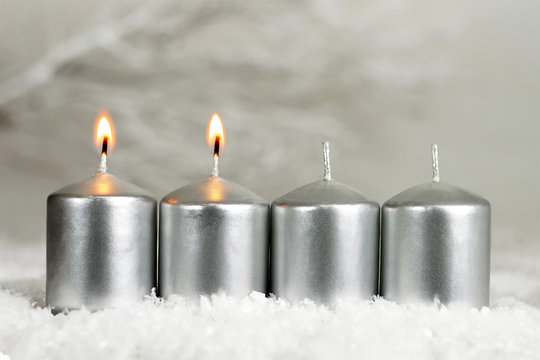 Four Advent candles. Two candles burning
