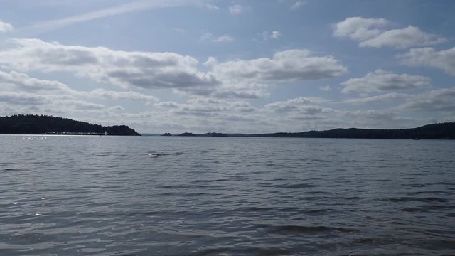 Soothing view of the lake mjorn with sailboats in the distance a beautiful summer day