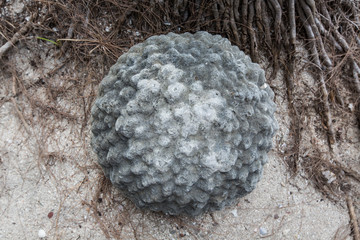 a unique ball shaped of a granite stone on the  sand
