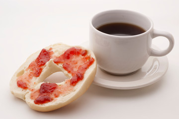 bagel with strawberry preserves and coffee