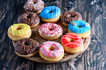 Obraz na płótnie Canvas Glazed donuts on wooden background top view