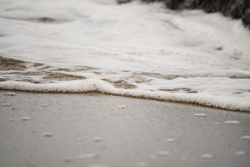 Close-up of Water Rolling onto Shore