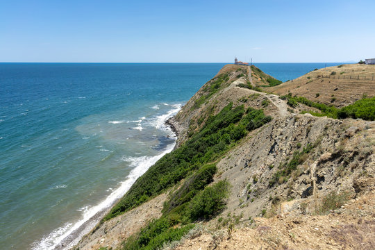 Natural landscape. The rocky coast of Cape Emine. The Bulgarian Black Sea Coast. In the background is the lighthouse building.