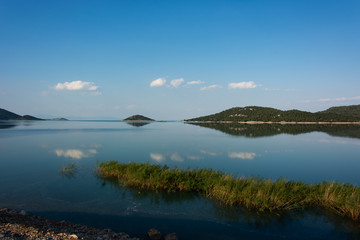 Obraz premium lake clouds islands and reflections