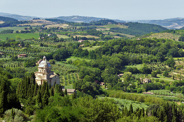 Fototapeta na wymiar Panoramic view of the Tuscan hills of Montepulciano overlooking the christian temple of San Biagio