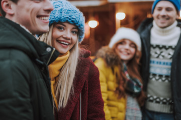 Positive delighted blonde girl looking at camera