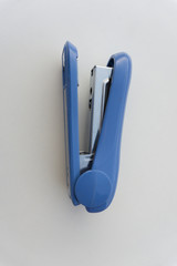 Blue stapler isolated on white background.