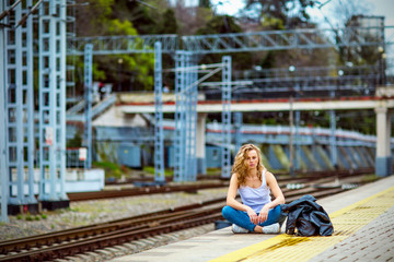 girl with freckles without makeup, near the yellow train at the station