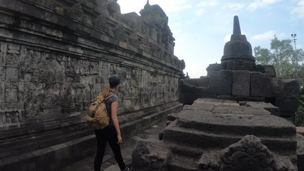 Tourist backpacker exploring the Borobudur temple in Java island,Indonesia