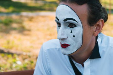 Close-up of a young mime in a park
