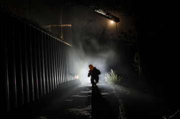 Horror scene of a scary children's ghost, Silhouette of scary baby doll on dark foggy background...